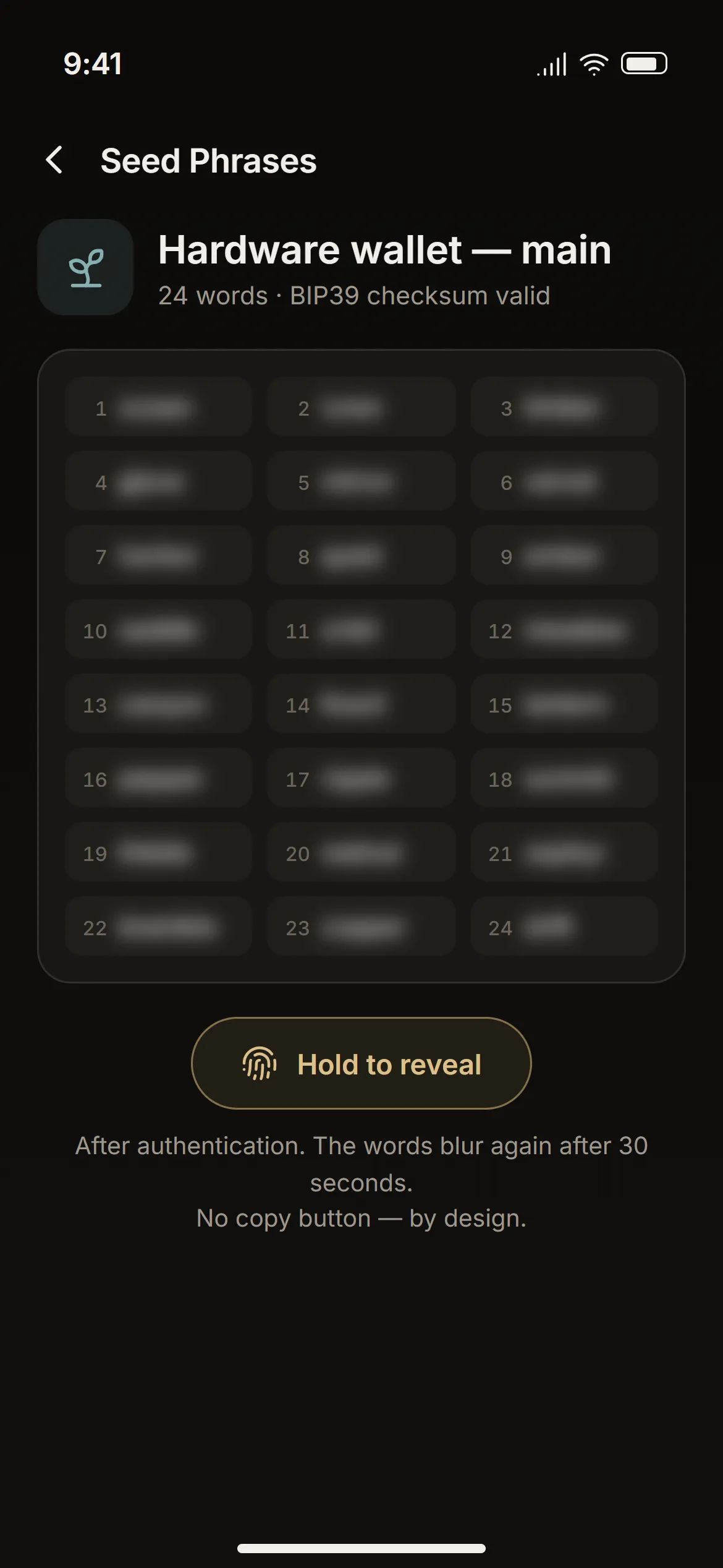 The seed phrase screen with the words blurred and the “Hold to reveal” control.